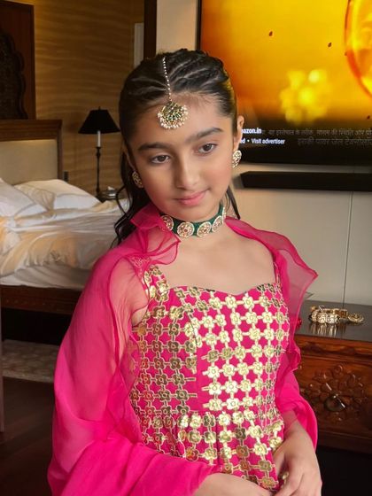 Another angle of the youthful braided ponytail, showing how it's both stylish and practical for a child attending a wedding or festival.