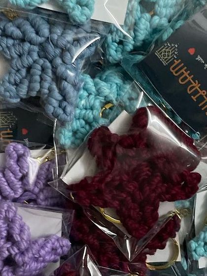 A box full of colorful star keychains, ready to be shipped out for a bulk order. I love seeing them all together like this.