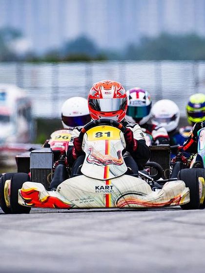 A tight formation of karts heading into the first corner.