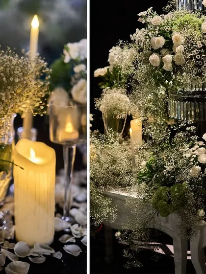 The warm glow of candles scattered among white floral arrangements. I use lighting extensively to create a romantic and intimate mood for evening events.