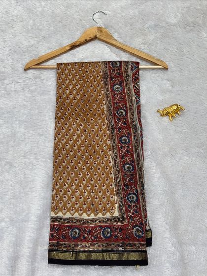 An elegant Chanderi silk saree with a traditional Bagru print border. The combination of earthy tones and classic motifs makes this a very graceful and versatile piece.