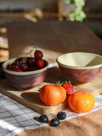 These fruit bowls, with their rich, earthy tones, are part of a student's graduation collection. They are a beautiful example of functional art inspired by nature.