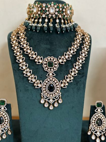 A full view of the modern layered necklace set with black and green stones. This rental set is perfect for a reception or cocktail event.