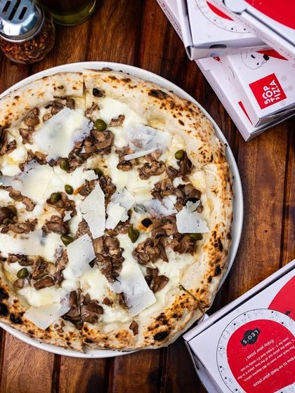 Our Bianca pizza with mushrooms, ready for takeout. Enjoy our gourmet pizzas at home.