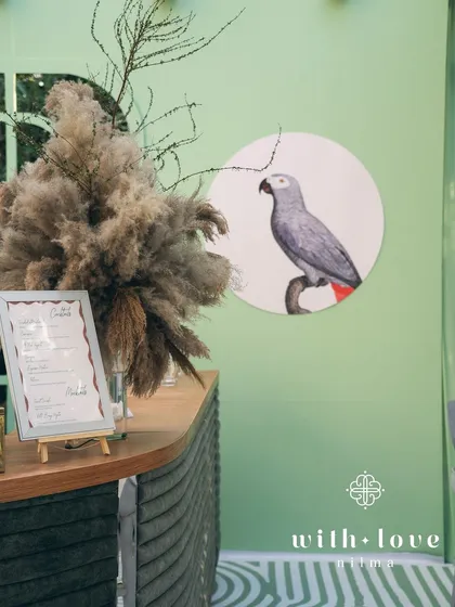 A detail of the custom bar at the baby shower, with a framed menu and pampas grass arrangement.