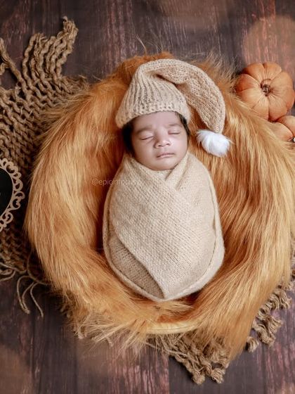 A 'Fairy Tales' theme with a baby in a soft fur-lined basket, surrounded by pumpkins and rustic textures for a cozy, autumnal feel.