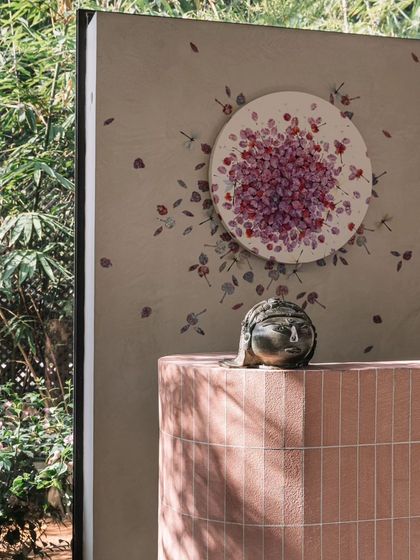 A close-up of the pink brick bar and the custom artwork by Dhara Mehrotra. The piece, featuring dragonflies, adds a delicate, artistic element to the room.
