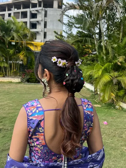 This unique hairstyle is a true conversation starter, blending traditional elements with playful, modern accessories.