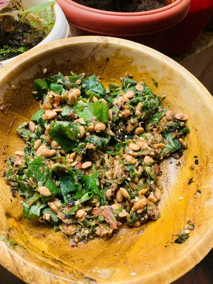 A fresh batch of my homemade Axone chutney. I make this by pounding fermented soya beans with roasted green chillies, tomato, ginger, and garlic, then finish it with fresh green leaves from my garden. The flavour is strong, pungent, and very traditional.
