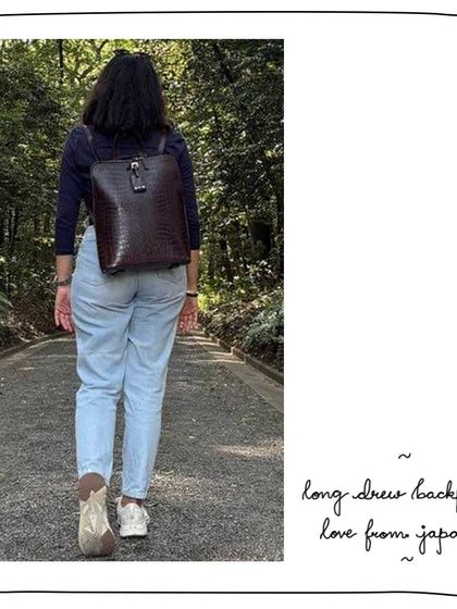 Anuja exploring Japan with her Long Drew Backpack in Morocco croc-embossed leather. A functional and fashionable choice for travel.