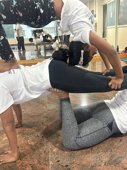 Stronger together. This impressive three-person pose showcases the incredible strength, balance, and teamwork of my dedicated students. It's a beautiful example of what we can achieve when we support one another.
