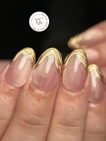 A close-up of these textured gold chrome French tips, showing the beautiful dimension and shine perfect for the festive season.