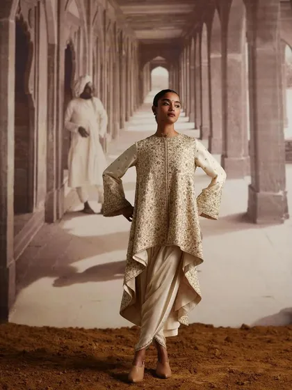 A unique silhouette from the AR by Rhea Kapoor campaign. The asymmetrical kurta paired with a dhoti-style bottom is a high-fashion choice for a pre-wedding event.