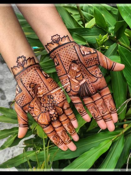 This design focuses on the couple, with a portrait of the bride and groom on each palm. The natural green background makes the rich henna stain stand out, highlighting the intricate details of their wedding attire.