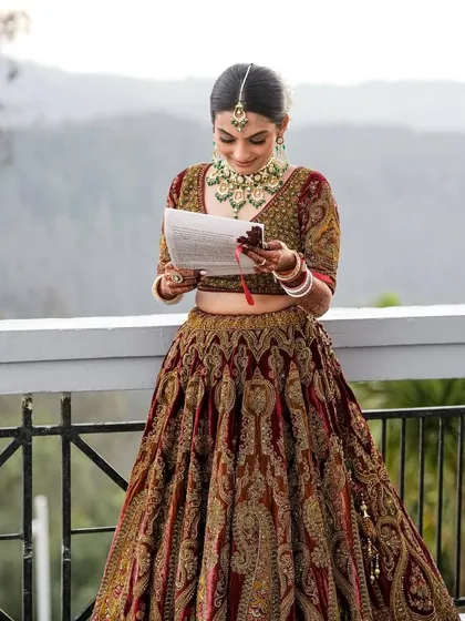 The bride reading her vows. Her makeup is elegant and understated, allowing her emotions and the beautiful setting to take center stage.