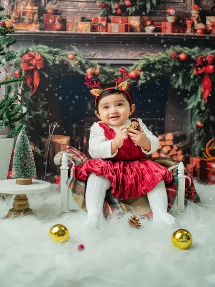 Adding a touch of fun with reindeer antlers. This little girl is enjoying the festive props.