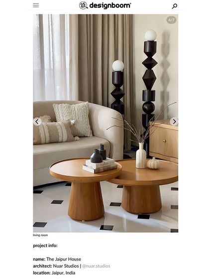 Another screenshot from the designboom article, highlighting the living room details and sculptural floor lamps of the Jaipur House.