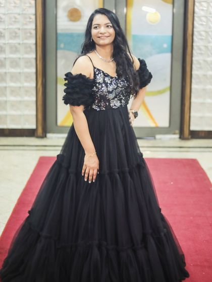 A full shot of the client in the black gown, looking elegant and ready for her event.