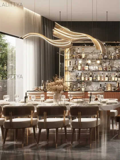 This is where dinners turn into long, happy hours. We paired a statement dining table with a fully stocked, back-lit bar unit, all under the glow of a sculptural, ribbon-like light fixture.