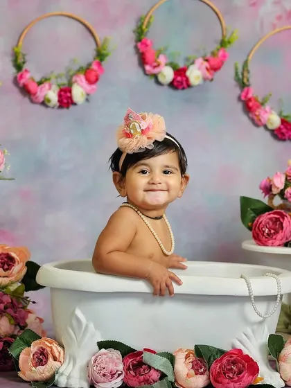 A beautiful bath time photo surrounded by pink flowers. This sitter session combines a classic tub shot with a lovely floral theme.