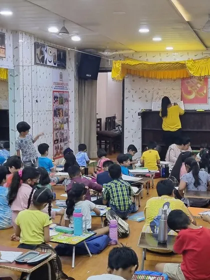 A wide view of our studio during a summer camp session. The room is buzzing with creative energy as children work on their art projects.