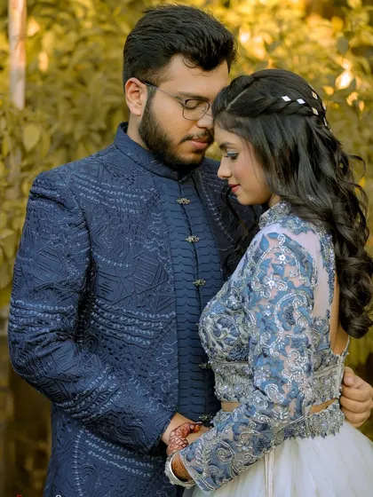 A romantic portrait of the couple during their engagement session. The soft light and their close embrace create a feeling of warmth and intimacy.