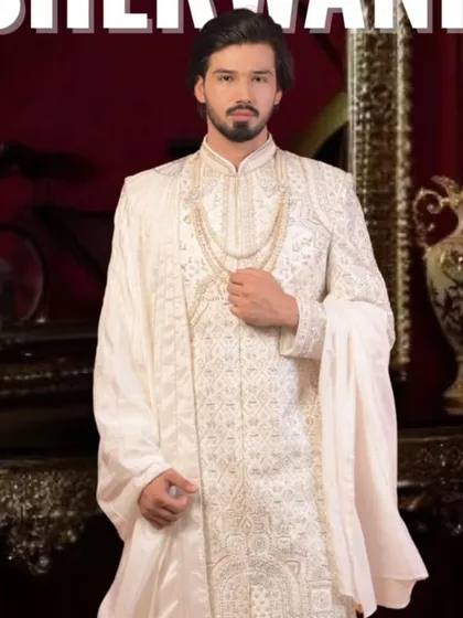 This is our classic off-the-rack groom's sherwani in a timeless white. It features delicate, all-over embroidery and comes as a full set with a matching mala and dupatta. It’s the perfect choice for a groom who wants a royal and elegant look, ekdum ready for the big day.