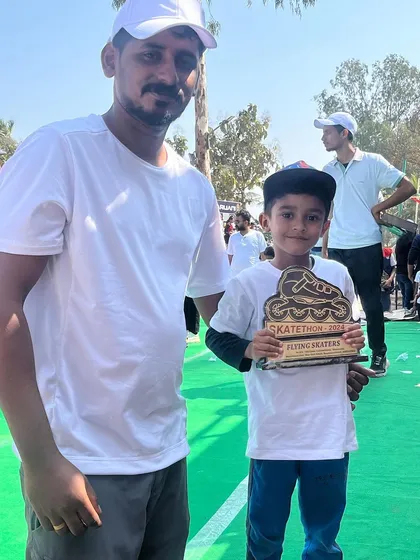 A young winner with his coach and a custom Skatethon trophy. Our events are a celebration of personal achievement and community support.