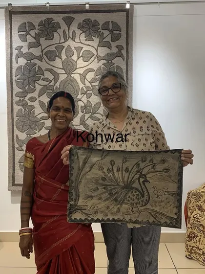 Proudly holding my finished Khovar painting of a peacock alongside the master artist who taught the workshop.