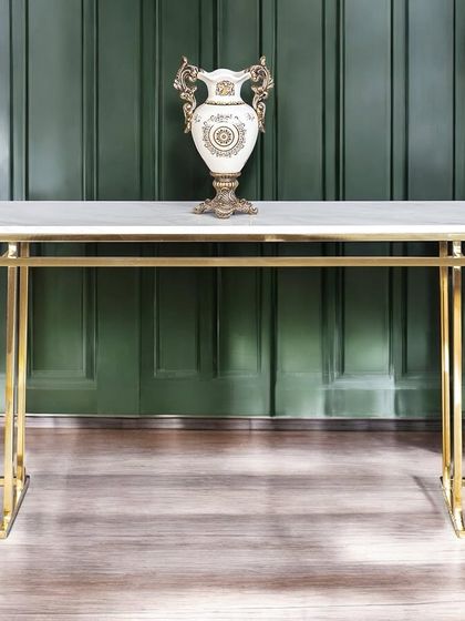 The Square Piped Marble Top console table offers a clean, geometric aesthetic. The golden stainless steel frame is both sturdy and elegant, creating a timeless look that complements a variety of interior styles.