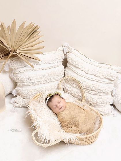 Wrapped in the softest hues of love and tranquility. This boho-inspired newborn setup uses natural textures and a neutral palette to create a calm and peaceful portrait.