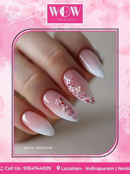 A beautiful and delicate floral design on long, almond-shaped nails. The soft pink and white ombré base is the perfect canvas for the hand-painted cherry blossoms.