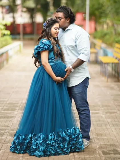 Planning a couple's maternity shoot is a wonderful way to capture this time together. Here, my client wears the teal floral gown while her partner stays comfortable and casual. I can help you style a coordinated look that feels authentic to you both.