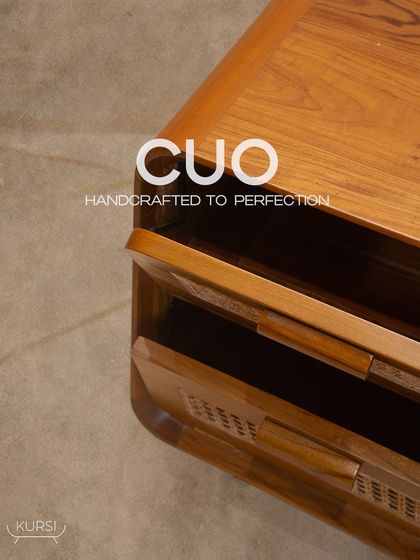 A top-down view of the 'Cuo' side table, showing the rich grain of the teak wood and the elegant, curved silhouette. Handcrafted to perfection.