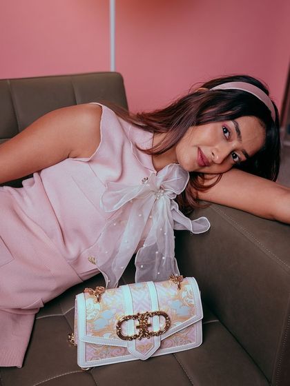 A full look at the adorable styling of our organza pearl bow, paired with a pink dress.