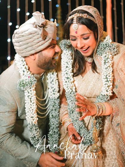A moment of shared laughter and joy between the couple during their Jaimala ceremony, a perfect candid portrait.