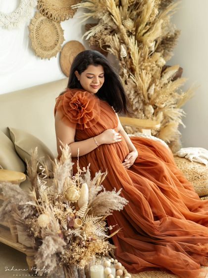 A full-length shot showing the beautiful flow of the rust-colored gown against our popular rustic studio backdrop. This setup is perfect for creating warm, earthy portraits.
