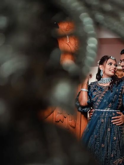 A creative reception shot, using foreground blur to create an artistic and intimate portrait of the couple.