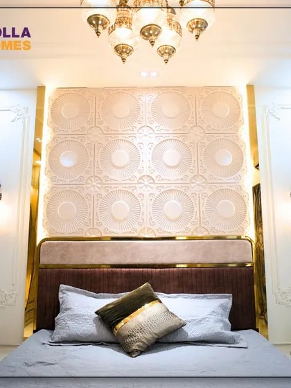 The master bedroom in our Parisian-themed project. The headboard is set against an intricate, backlit wall panel, complemented by classic wall sconces and a grand chandelier, creating a feeling of pure indulgence.