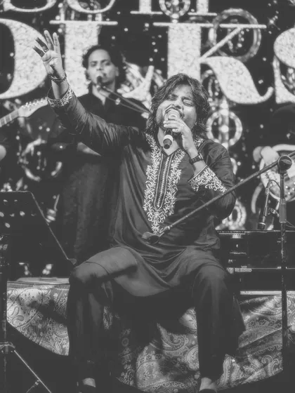 A timeless black and white shot of a passionate performance. This image strips away the color to focus on the raw emotion and spiritual energy of the music.