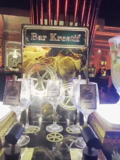 The 'Bar Kreatif' station, where I offer unique and creative beverage options. The presentation includes a large glass dispenser with infused water or sangria.