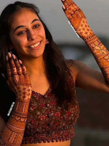 A smiling client with her lovely engagement mehndi, perfect for celebrating her special day.