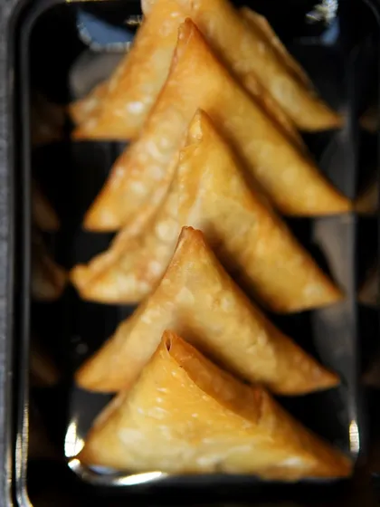 Perfectly golden and crispy Chicken Samosas, ready to be served. A timeless classic for any event.