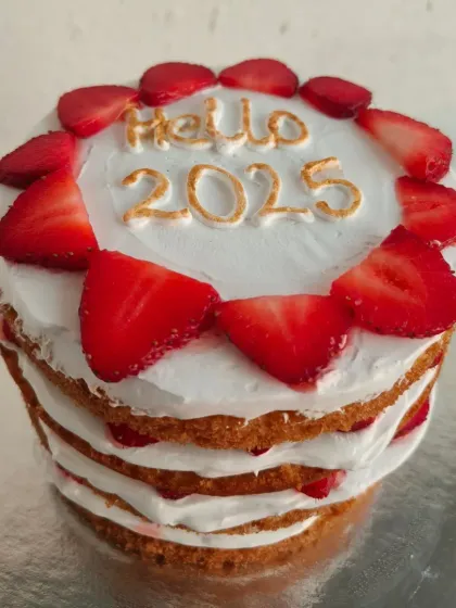Ring in the new year with a beautiful layered cake like this "Hello 2025" creation. It's made with fresh strawberries and light vanilla cream, offering a fresh and festive start to the year.