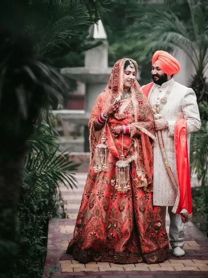 The couple shares a look in a beautiful garden pathway.