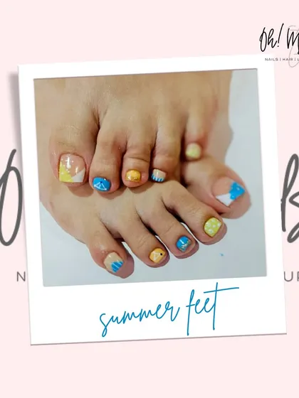 Get your feet summer ready with our creative pedicure nail art. This photo shows a playful design with bright yellow and blue polish, perfect for a beach vacation or just to add a pop of color. We make sure your toes look as good as your hands.