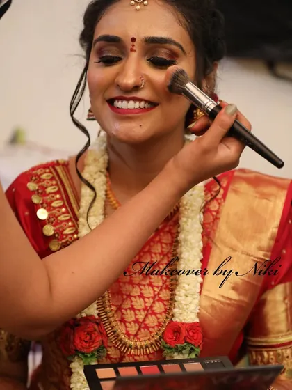 A smile during the process. I love seeing my brides happy and relaxed as their look comes together. Here, I'm applying blush to enhance Pooja's beautiful smile.