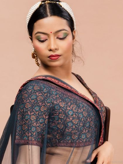 An intimate close-up of the model in a lehenga, highlighting the details of the blouse and makeup.