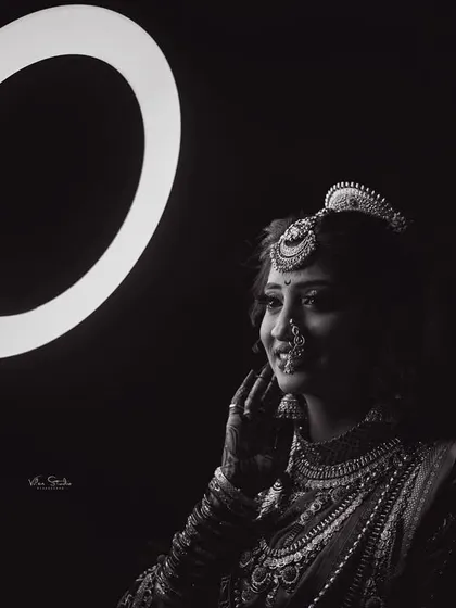A beautiful black and white portrait where the ring light creates a halo effect. The bride's expression is soft and thoughtful, resulting in a timeless and artistic photograph.