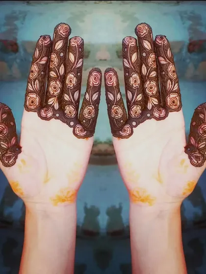 This design focuses on the fingers, with intricate rose patterns creating a look that is both full and delicate. It's a great choice for someone who wants detailed work without covering the entire palm.